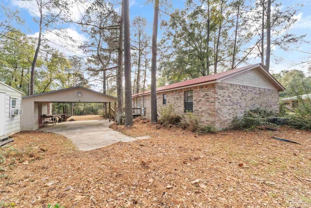 view of side of home with a carport