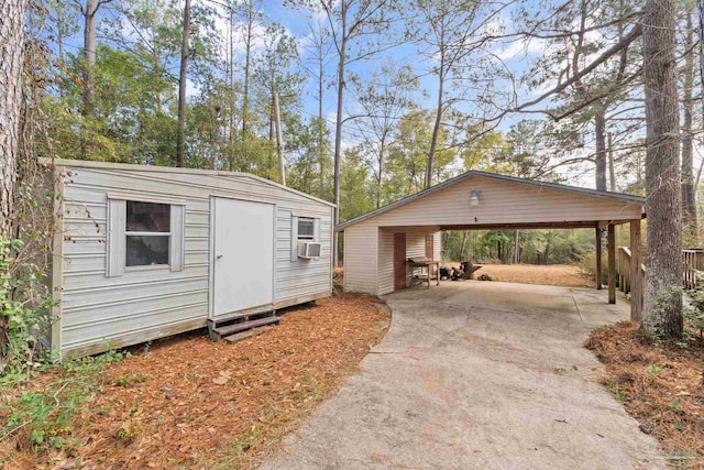 view of outdoor structure featuring cooling unit and a carport