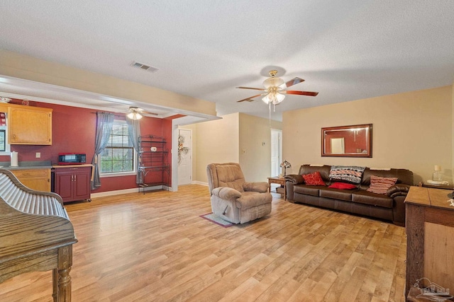 living room featuring light hardwood / wood-style floors and a textured ceiling