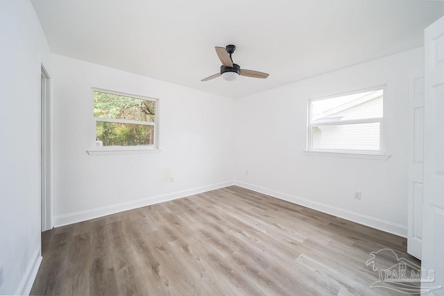 empty room featuring ceiling fan and light hardwood / wood-style floors