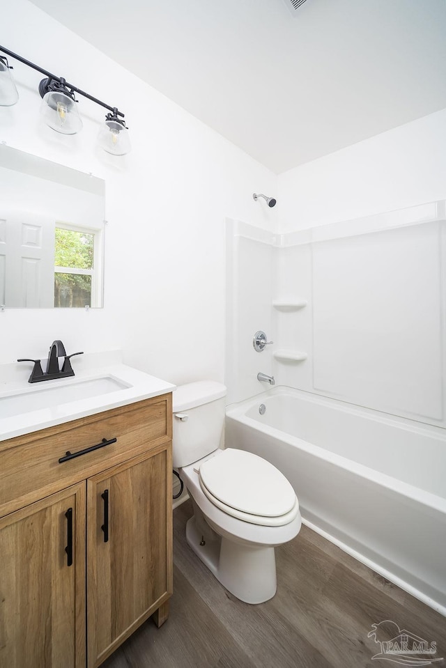 full bathroom featuring shower / tub combination, vanity, toilet, and wood-type flooring