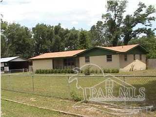 ranch-style home with fence