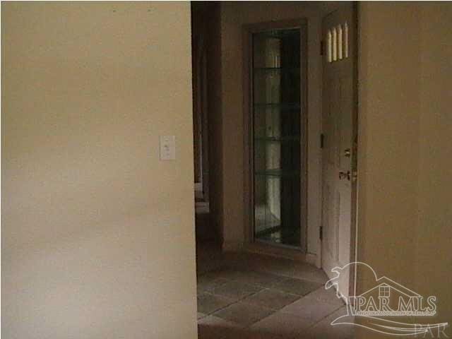 hall featuring tile patterned flooring