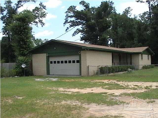 view of side of property with a yard and fence
