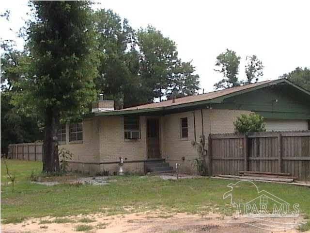 rear view of property with fence
