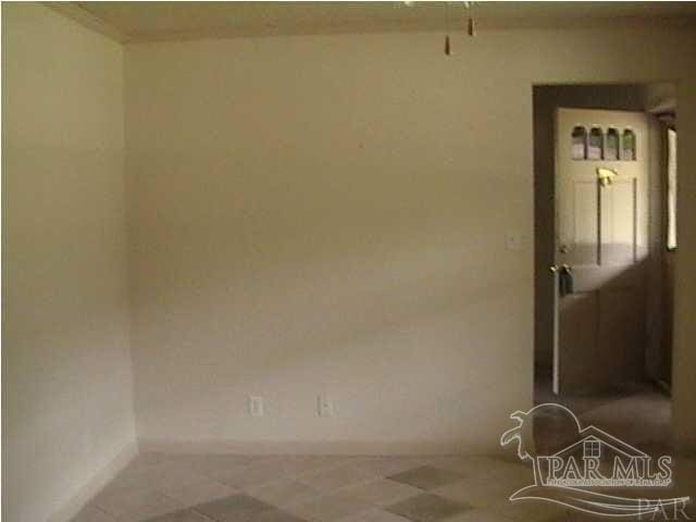 spare room featuring baseboards