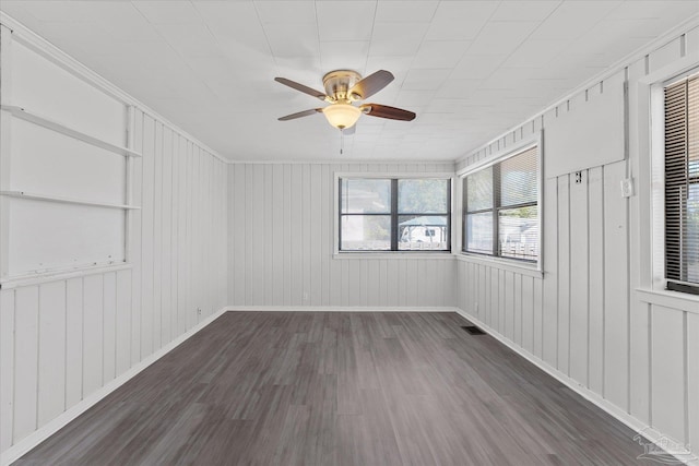 empty room with dark wood-type flooring and ceiling fan