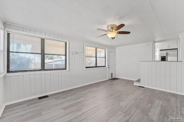 spare room featuring light hardwood / wood-style floors and ceiling fan