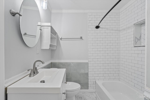 full bathroom featuring tile walls, tiled shower / bath combo, vanity, ornamental molding, and toilet