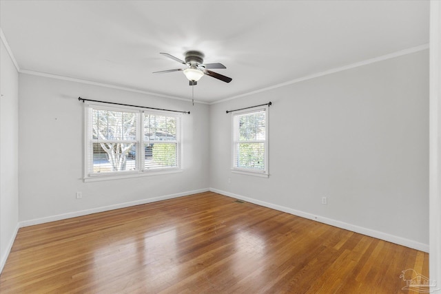 empty room with hardwood / wood-style flooring, ornamental molding, and ceiling fan