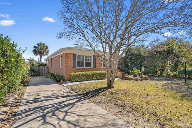 view of property exterior with a lawn