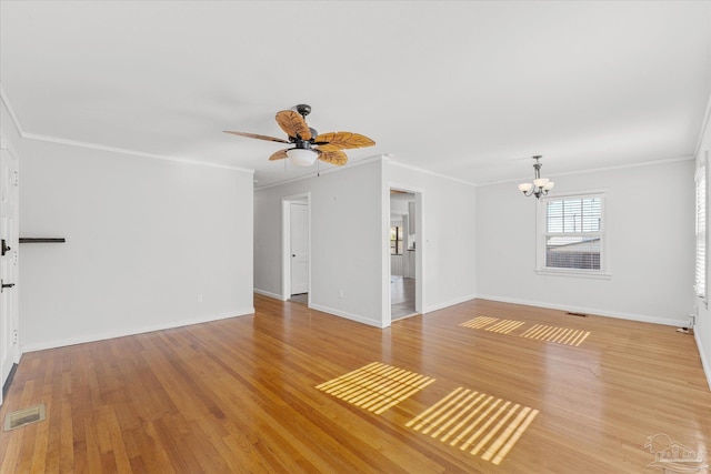 unfurnished living room with ceiling fan with notable chandelier, ornamental molding, and light hardwood / wood-style floors