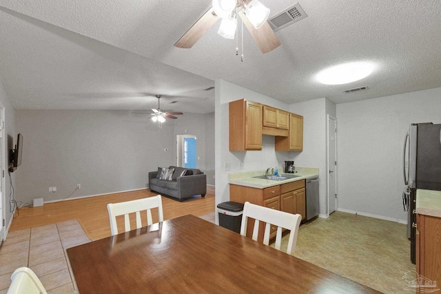 carpeted dining room featuring lofted ceiling, sink, and a textured ceiling