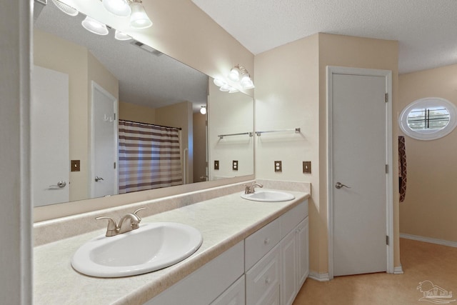 bathroom featuring vanity and a textured ceiling