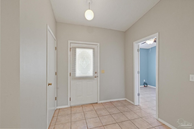 foyer entrance featuring light tile patterned floors and a textured ceiling