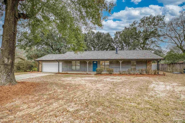 ranch-style home featuring a garage and covered porch