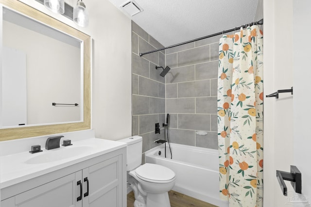 full bathroom with toilet, a textured ceiling, vanity, shower / bath combo with shower curtain, and hardwood / wood-style flooring