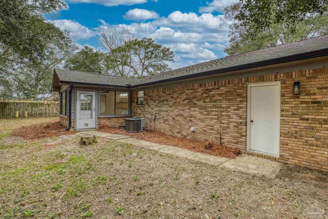 back of house with central AC unit