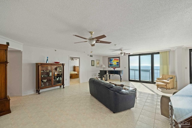 living room with floor to ceiling windows, a water view, crown molding, ceiling fan, and a textured ceiling