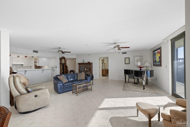 tiled living room featuring a textured ceiling