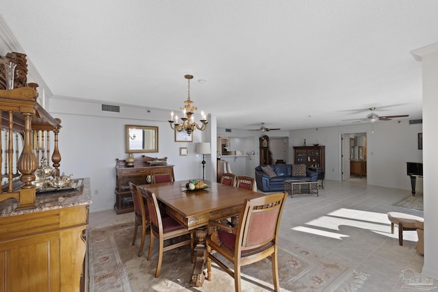 dining space with ceiling fan with notable chandelier