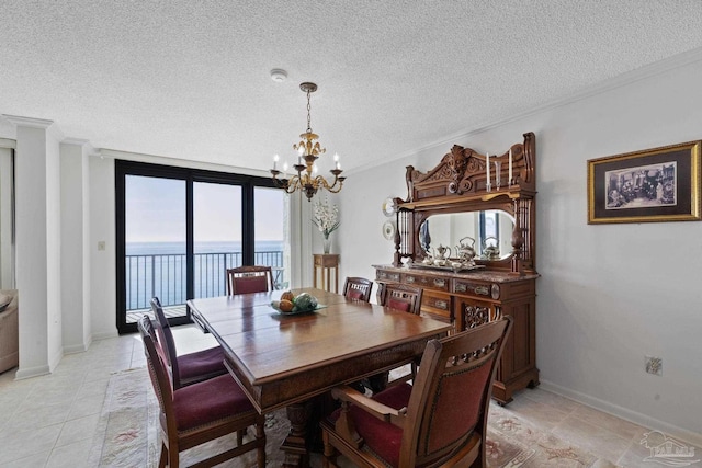 dining space with floor to ceiling windows, a water view, a chandelier, and a textured ceiling