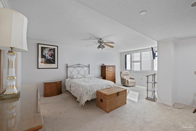 carpeted bedroom featuring a textured ceiling and ceiling fan