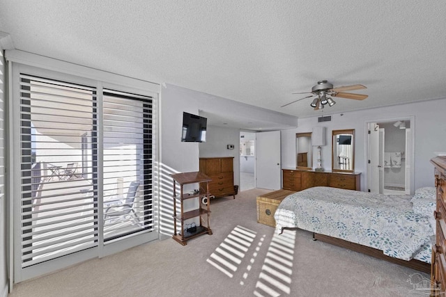 carpeted bedroom with multiple windows, a textured ceiling, and ceiling fan