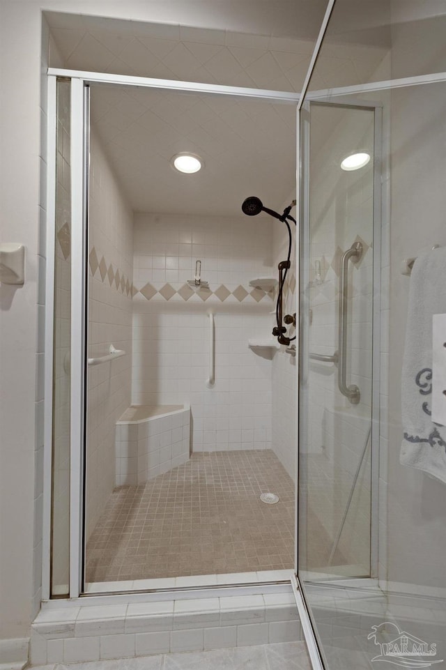 bathroom featuring a shower with door