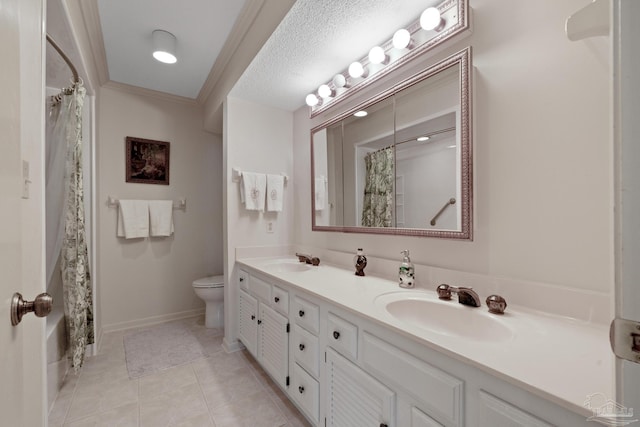 bathroom with vanity, a textured ceiling, crown molding, tile patterned flooring, and toilet