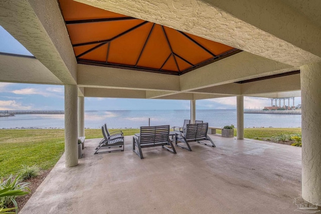 view of patio with outdoor lounge area and a water view