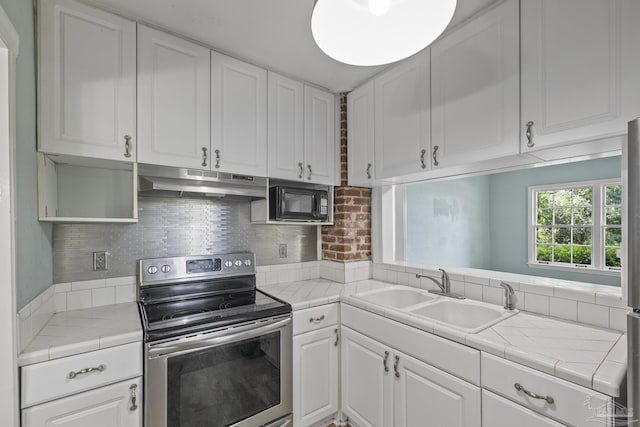 7074 Milton Ct, Milton, FL 32583 - kitchen featuring stainless steel electric range, under cabinet range hood, a sink, white cabinetry, and tasteful backsplash