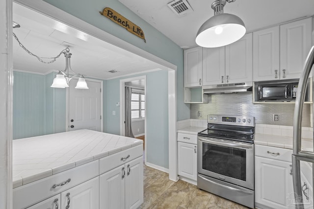 7074 Milton Ct, Milton, FL 32583 - kitchen featuring appliances with stainless steel finishes, tile countertops, under cabinet range hood, white cabinetry, and tasteful backsplash