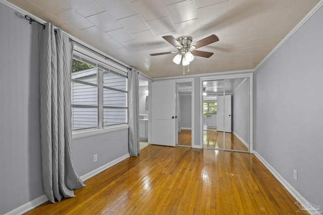 7074 Milton Ct, Milton, FL 32583 - unfurnished bedroom with wood-type flooring, baseboards, and ceiling fan