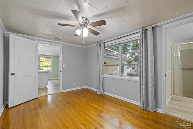 7074 Milton Ct, Milton, FL 32583 - unfurnished bedroom with light wood finished floors, baseboards, ceiling fan, and ornamental molding