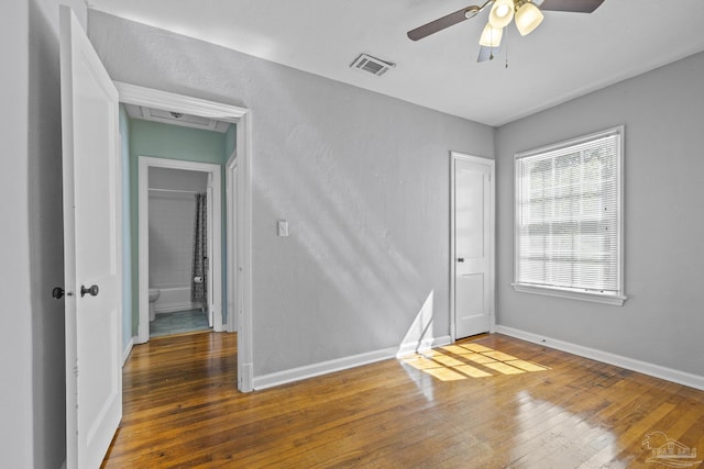 7074 Milton Ct, Milton, FL 32583 - empty room with ceiling fan, wood-type flooring, and baseboards