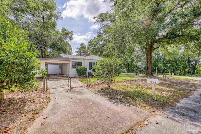 7074 Milton Ct, Milton, FL 32583 - ranch-style home featuring a gate, driveway, and an attached carport