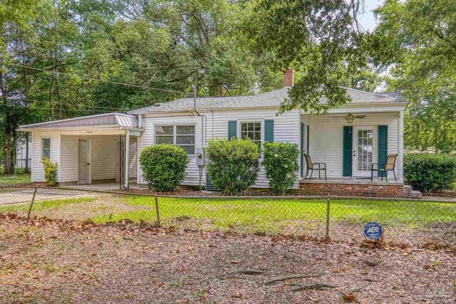 7074 Milton Ct, Milton, FL 32583 - view of front of house with a porch, a chimney, and an attached carport