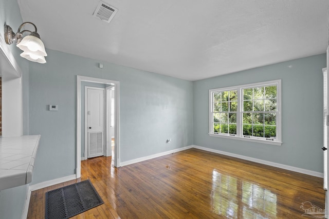 7074 Milton Ct, Milton, FL 32583 - unfurnished living room with hardwood / wood-style flooring and baseboards