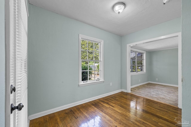 7074 Milton Ct, Milton, FL 32583 - empty room featuring wood-type flooring and baseboards