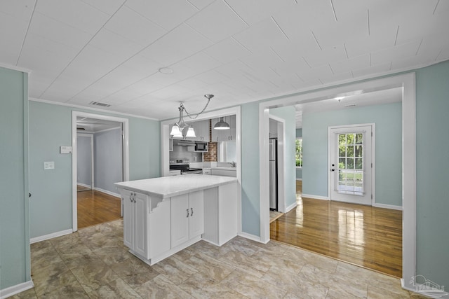 7074 Milton Ct, Milton, FL 32583 - kitchen featuring stainless steel appliances, a peninsula, light countertops, white cabinets, and decorative backsplash