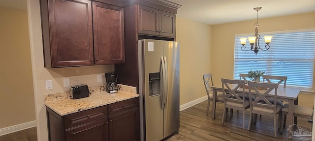 kitchen with baseboards, dark wood-type flooring, hanging light fixtures, a chandelier, and stainless steel refrigerator with ice dispenser