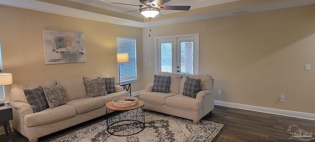 living room with a ceiling fan, dark wood finished floors, baseboards, french doors, and a raised ceiling