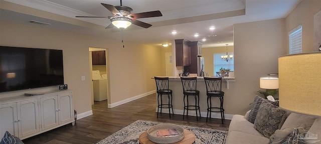 interior space featuring visible vents, baseboards, dark wood-style floors, separate washer and dryer, and ceiling fan with notable chandelier