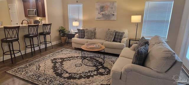 living room with dark wood-style flooring and baseboards