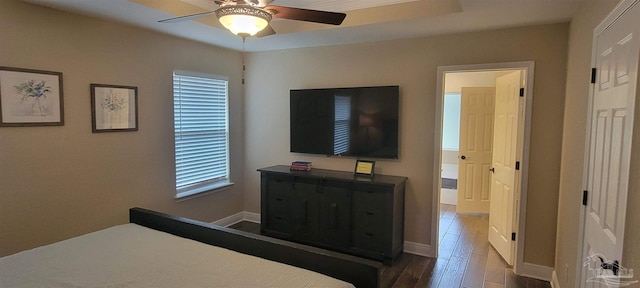 bedroom featuring a ceiling fan, baseboards, and wood finished floors