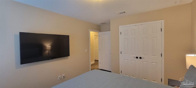 bedroom with a closet and visible vents