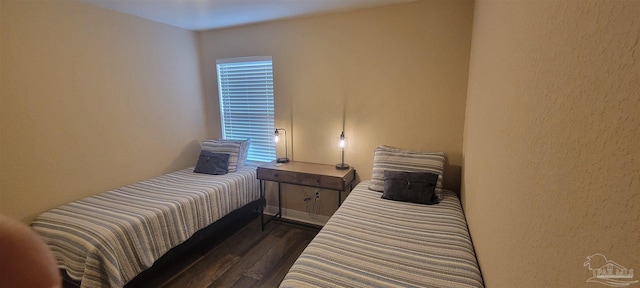 bedroom featuring dark wood-style floors and multiple windows