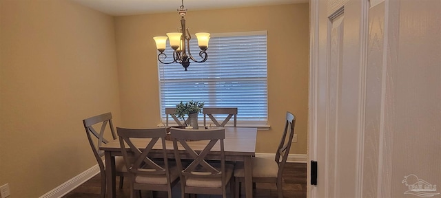 dining area featuring baseboards and a chandelier