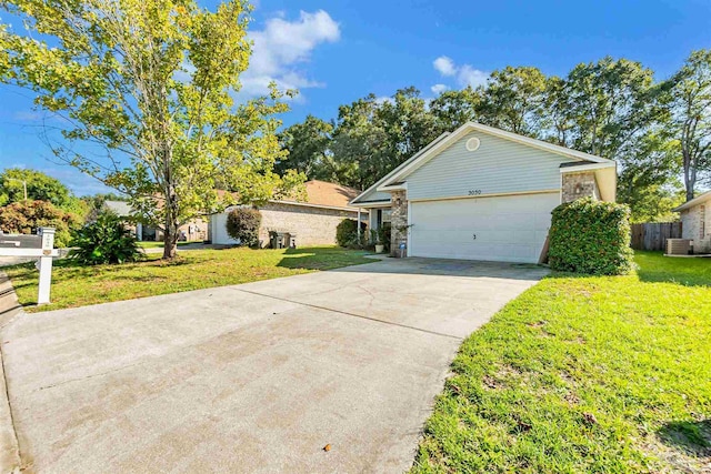 single story home with central AC unit, fence, an attached garage, a front lawn, and concrete driveway